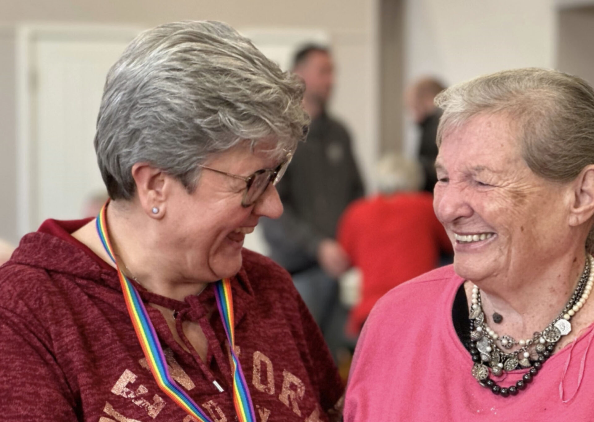 Two smiling women sharing a laugh